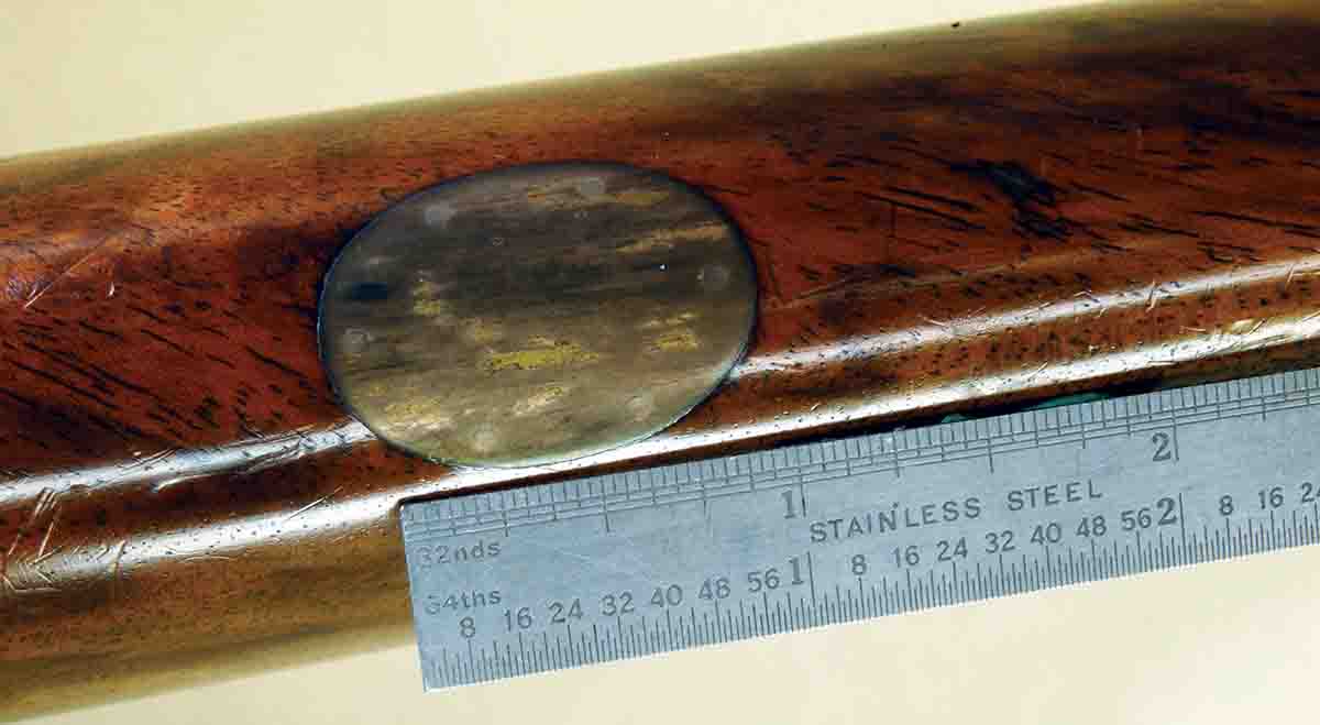 The large, unmarked oval in a double rifle may really be silver as indicated by the tarnished color.